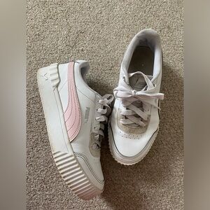 White and pink Puma sneakers.